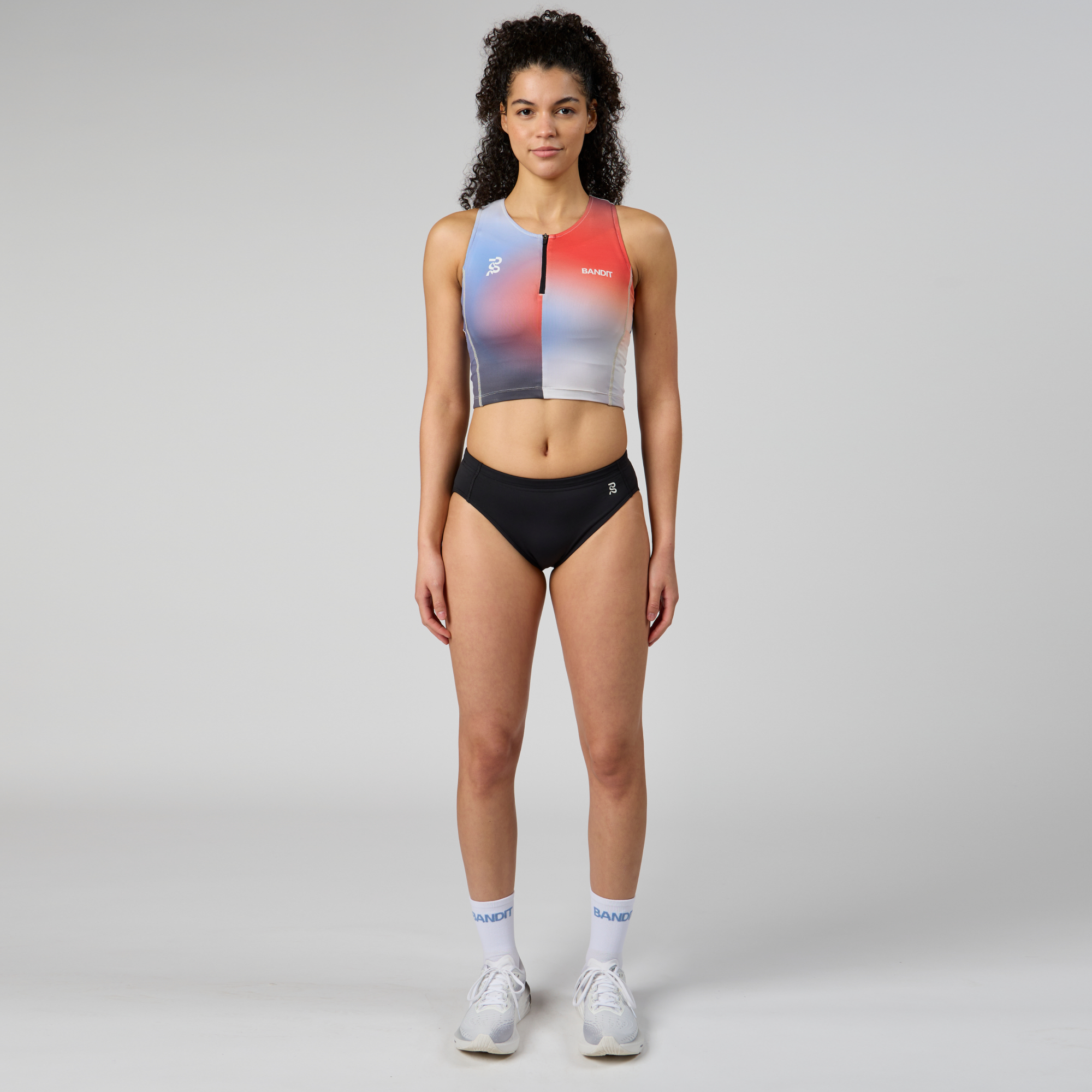 Full-length front view of the Stamina™ Racing Buns with pockets, designed for marathon racing season. Features a matte-finished fabric, reflective logo details, and a comfortable brushed elastic waistband.