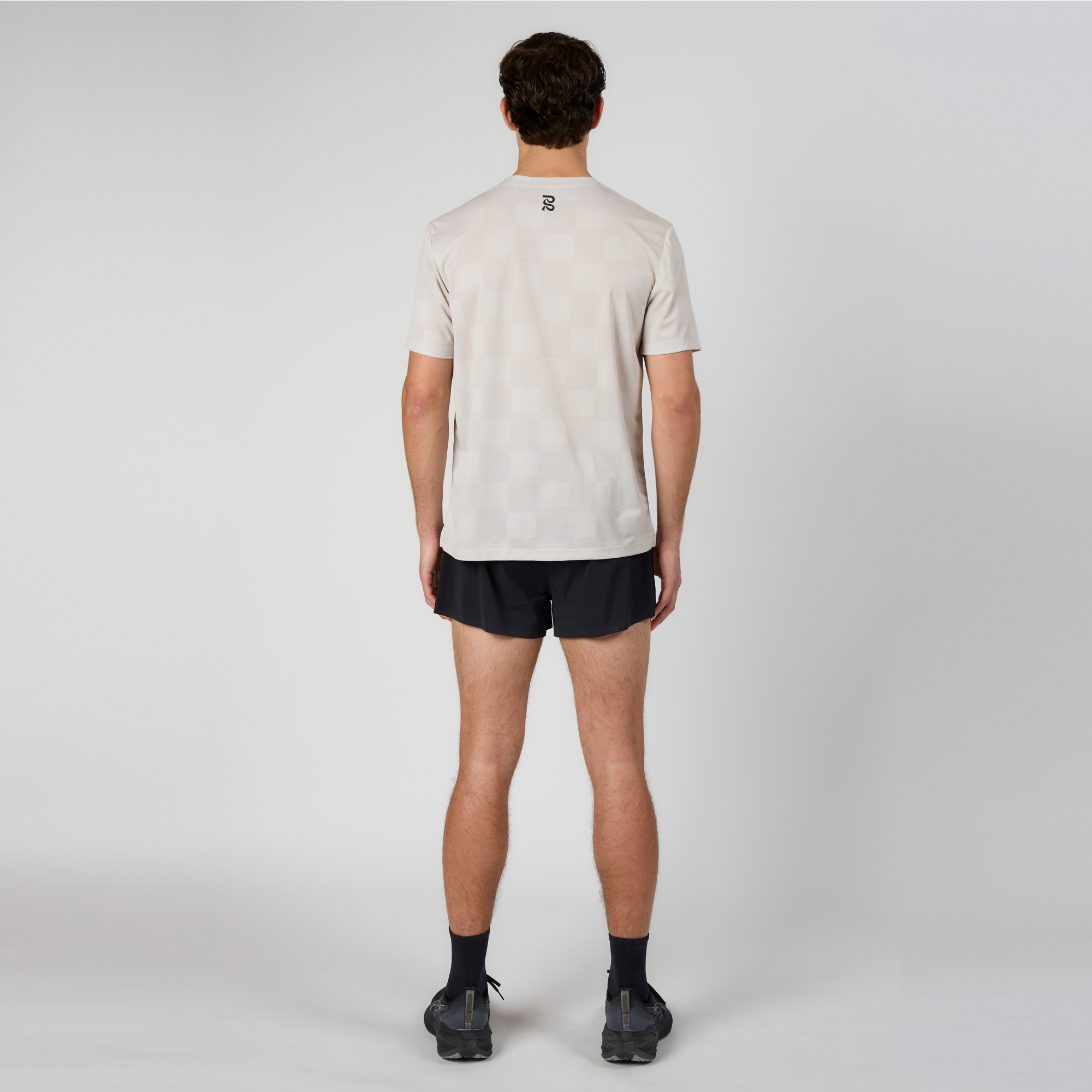 Full-body back view of model wearing the Vento™ 3" Split Short, featuring water-repellent finish and perforated fabric.