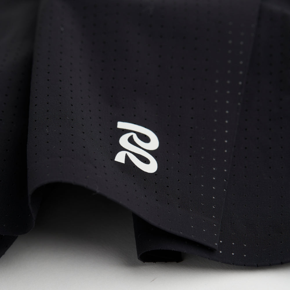 Close-up view of the Vento™ 5" Men's Training Short, highlighting the reflective logo on the front of the shorts and the micro-perforations in the fabric.
