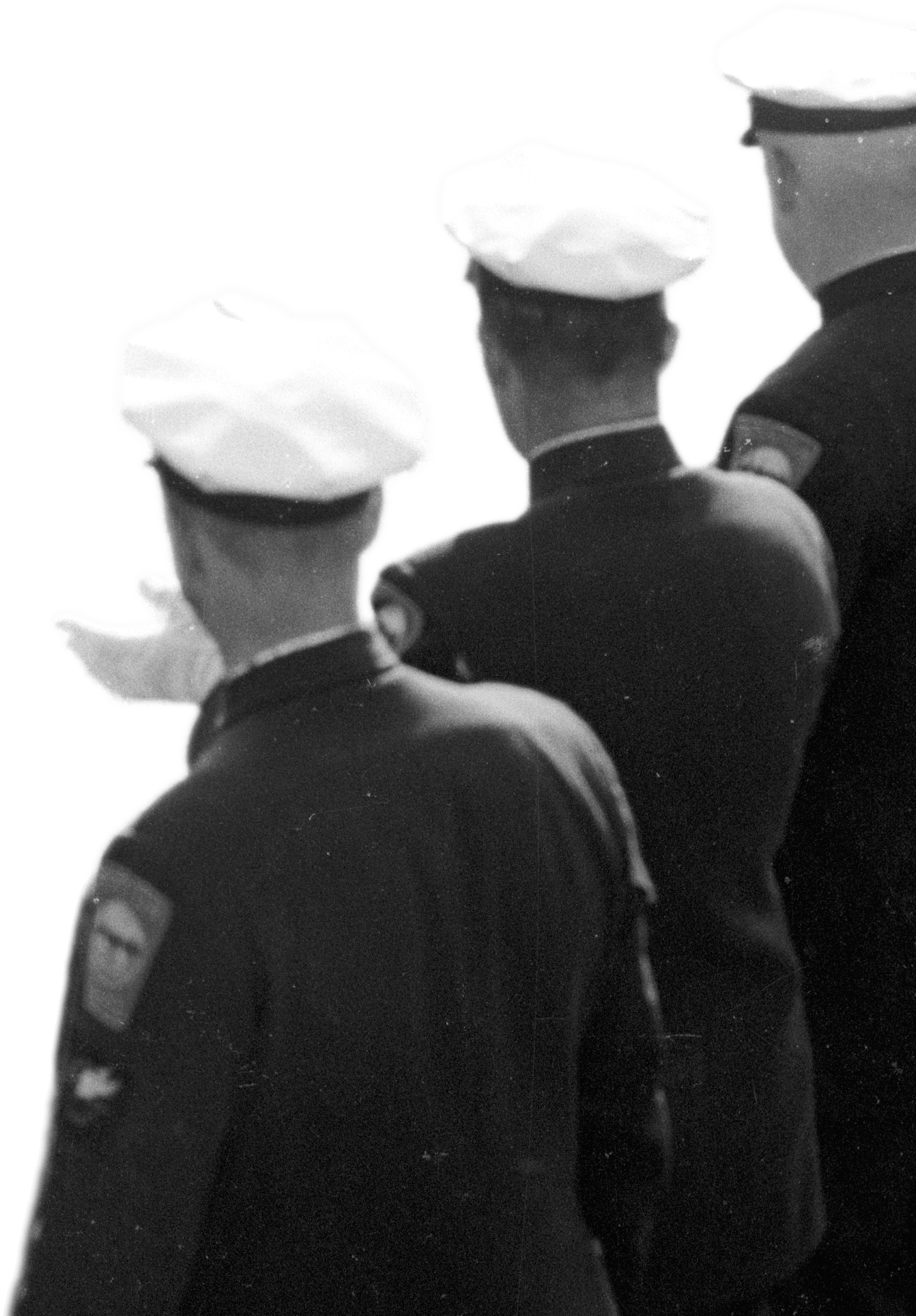 Three men in military uniforms standing together