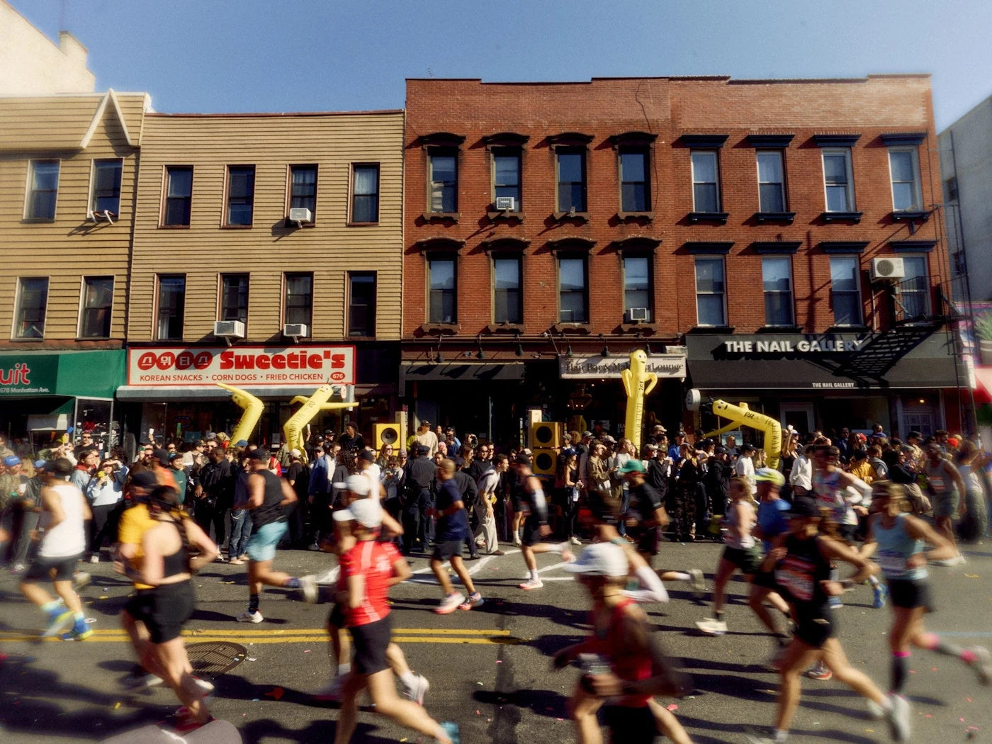 Marathon field passing a packed Brooklyn block