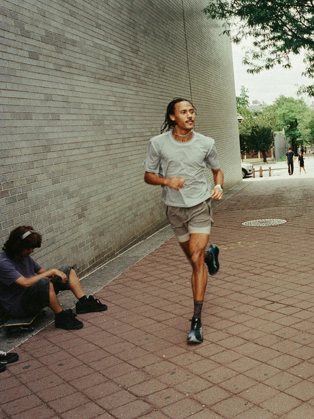 Runner passing a friend on a city sidewalk